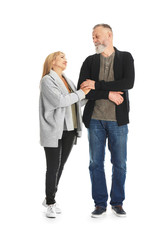 Mature couple in casual clothes walking on white background