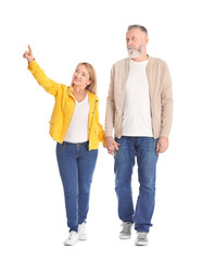 Fototapeta premium Mature couple in casual clothes walking on white background