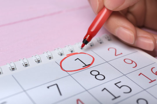 Woman Circling Date On Calendar, Closeup. April Fool's Day Celebration