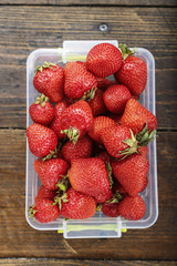 ripe strawberry in a plastic container