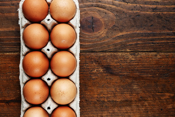 red chicken eggs on a wooden background