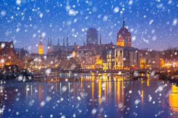 Fototapeta premium Old town of Gdansk on a cold winter night with falling snow, Poland
