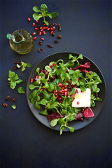Fresh salad with pomegranate, raisins and feta cheese. Detox food concept

