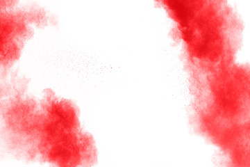 abstract red dust splattered on  white background. Red powder explosion on white background. Freeze motion of red particles splash.