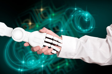 Handshake / Handshake of scientist and robot on technology background.