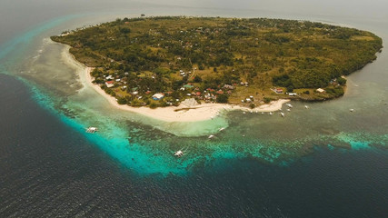 Aerial view of tropical beach on the island pamilacan, Philippines. Beautiful tropical island with sand beach, palm trees. Tropical landscape: beach with palm trees. Seascape: Ocean, sky, sea. Travel