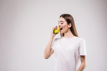 Young woman with healthy eating a red fresh apple on gray background. Health concept.