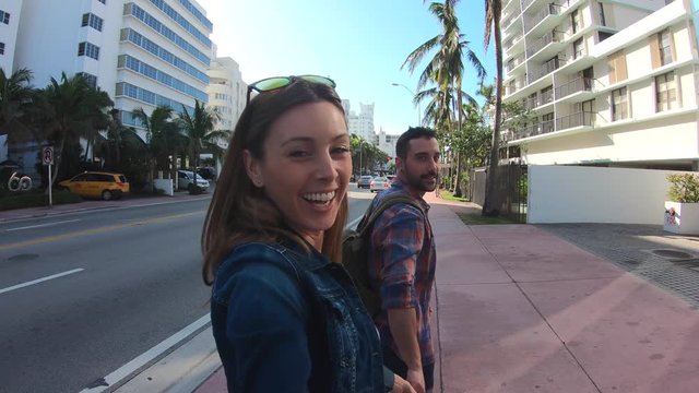Couple of tourists walking in the streets of Miami South beach