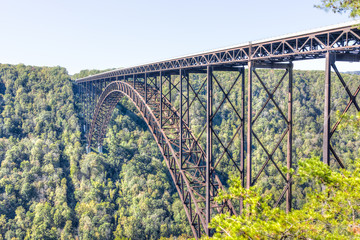 Overlook of West Virginia green mountains in spring, summer or autumn fall at New River Gorge Bridge with closeup of metal structure