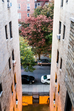 Aerial View Of Residential Apartment Building And Street Road With Sidewalk Between In Downtown Fordham Heights Area