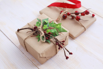 Christmas gift boxes and fir tree branch on wooden table. Сhristmas background