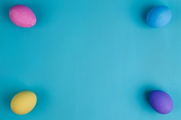 Multicolored Easter eggs on blue background, flat lay with copy space. Easter, spring, holidays, culture and religion concept
