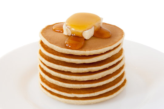 Pancakes Stack with Maple Syrup and Butter isolated on a white background. Food. Family Breakfast. Shrove Tuesday. Mardi Gras. Brunch. Snacks. Sweets. Dessert.