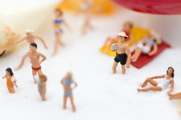 Miniature people : Travelers playing at the beach on vacation . Image use for activities, travel business concept.