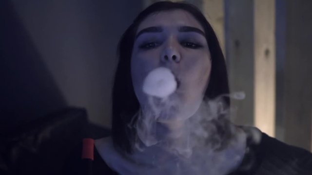 the girl smokes a hookah