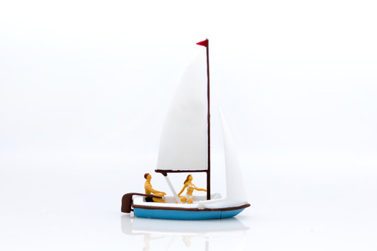 Miniature people: Tourists with sports sailing. Image use for travel business concept.