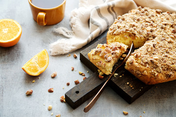 Orange pie with almonds. Gray wooden background
