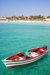 Fishing boat in turquoise water at the beach, pier of Santa Maria, Sal, Cape Verde Islands