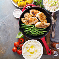 Grilled chicken with green beans in a skillet