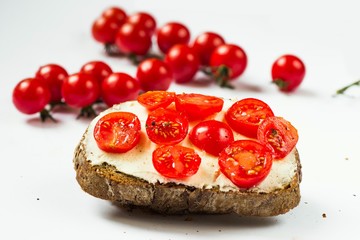 Bread with tomato, cherry tomato twigs.