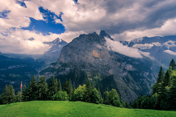 View from Murren on the Bernese Alps on a cloudy day in summer. Lauterbrunnen, Switzerland