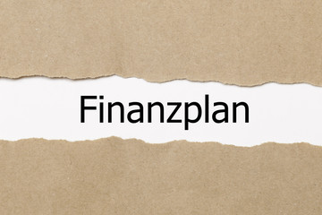Finanzplan (german for financial plan) written behind a torn paper