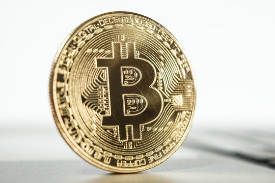 New virtual money Golden bitcoin coin on a white. Cryptocurrency. Business and Trading concept.
