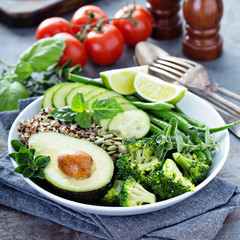 Green vegan lunch bowl with quinoa and avocado