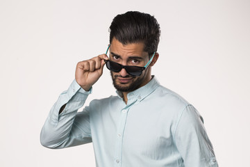 young male removing sunglasses 