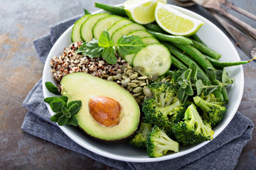 Green vegan lunch bowl with quinoa and avocado