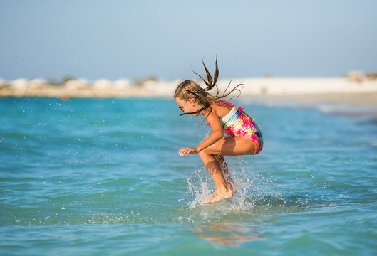 Young girl having fun in the waves.