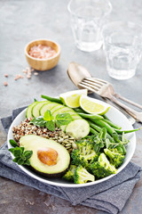 Green vegan lunch bowl with quinoa and avocado
