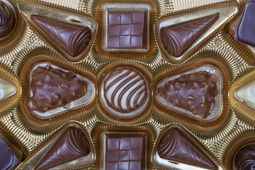 A box of chocolates with the golden colored case