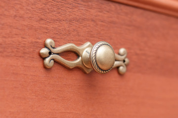 Handle old wooden chest of drawers closeup