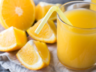 Fototapeta na wymiar Fresh orange juice on wooden background, rustic style