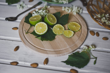 On a white table dishes with sliced lemon circles and nuts 436.