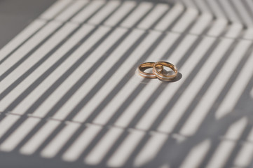 Wedding rings on shadow striped background 459.