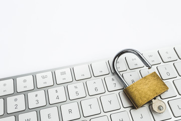 Background image of golden metal lock on keyboard