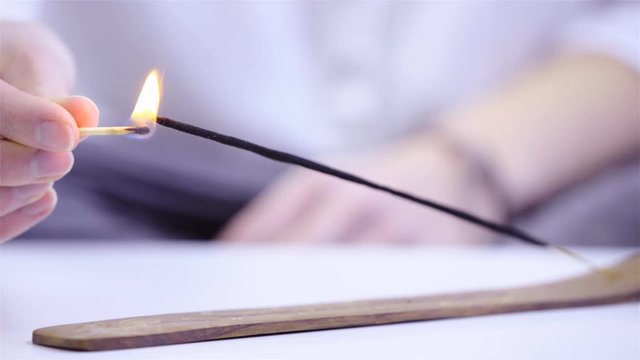 Lighting up incense with a match close up 4K