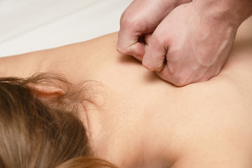 Obraz na płótnie Canvas Massage procedures on shoulders, back and cervical department
