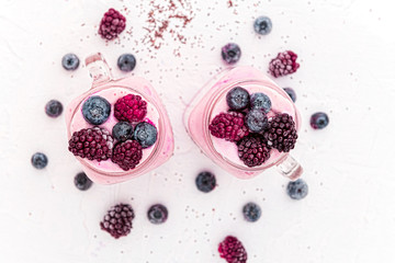chia with yoghurt, frozen bananas and wild berries, on a white background