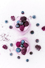 chia with yoghurt, frozen bananas and wild berries, on a white background