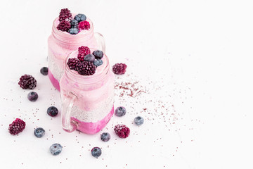 chia with yoghurt, frozen bananas and wild berries, on a white background