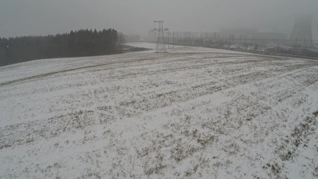 Power lines in the snow. Cogeneration plant in a strong blizzard