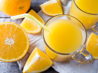 Fresh orange juice on wooden background, rustic style