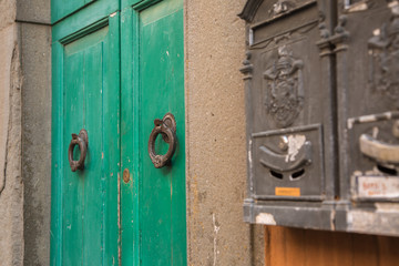 Close-up of Ancient Green Wooden Door with Iron Knob
