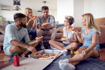 Group of friends eating pizza snack at home.