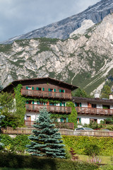 Fototapeta na wymiar Typical House in European Alps Mountain's Scenery in Summer Time