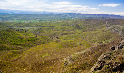 Fototapeta na wymiar Mountains and hills with trees against blue sky. Georgia.