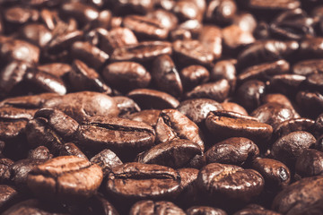 Background of  roasted coffee grains Food backdrop macro close-up